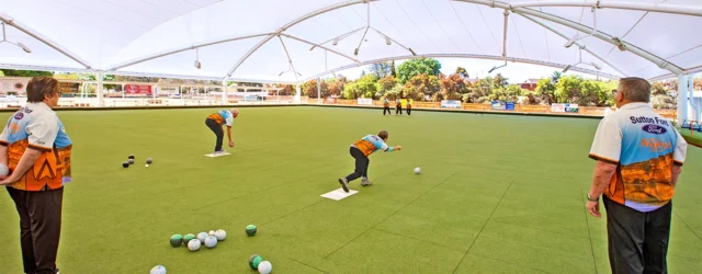 An Image of Lawn bowlers being protected from the sun by a canopy